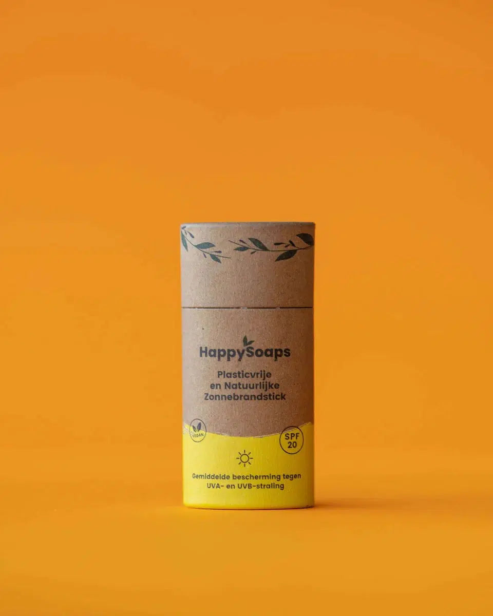 Een kartonnen buis met een gele label - Minerale Zonnebrandstick - Sunny Citrus - SPF 20